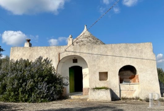 Awaiting renovation, a traditional, dry stone “trullo”, with a view of the sea, in Ostuni in the region of ...